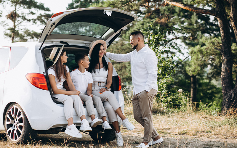 Family assessing trunk space for practical Singapore driving.