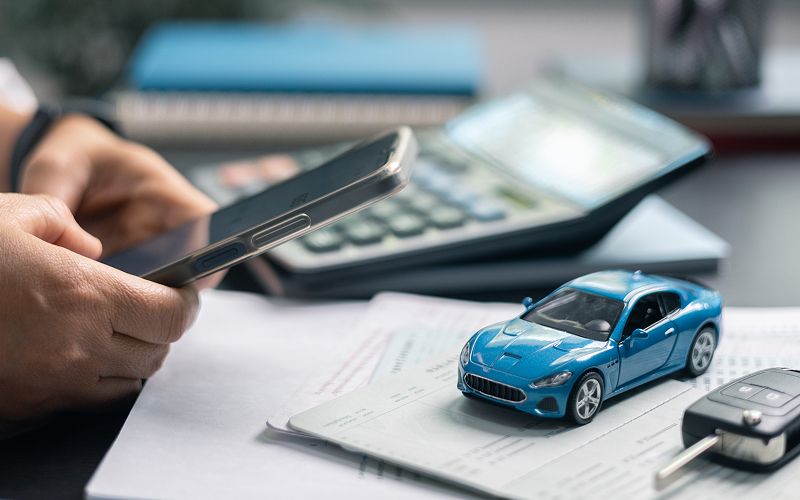 Person calculating monthly car ownership costs